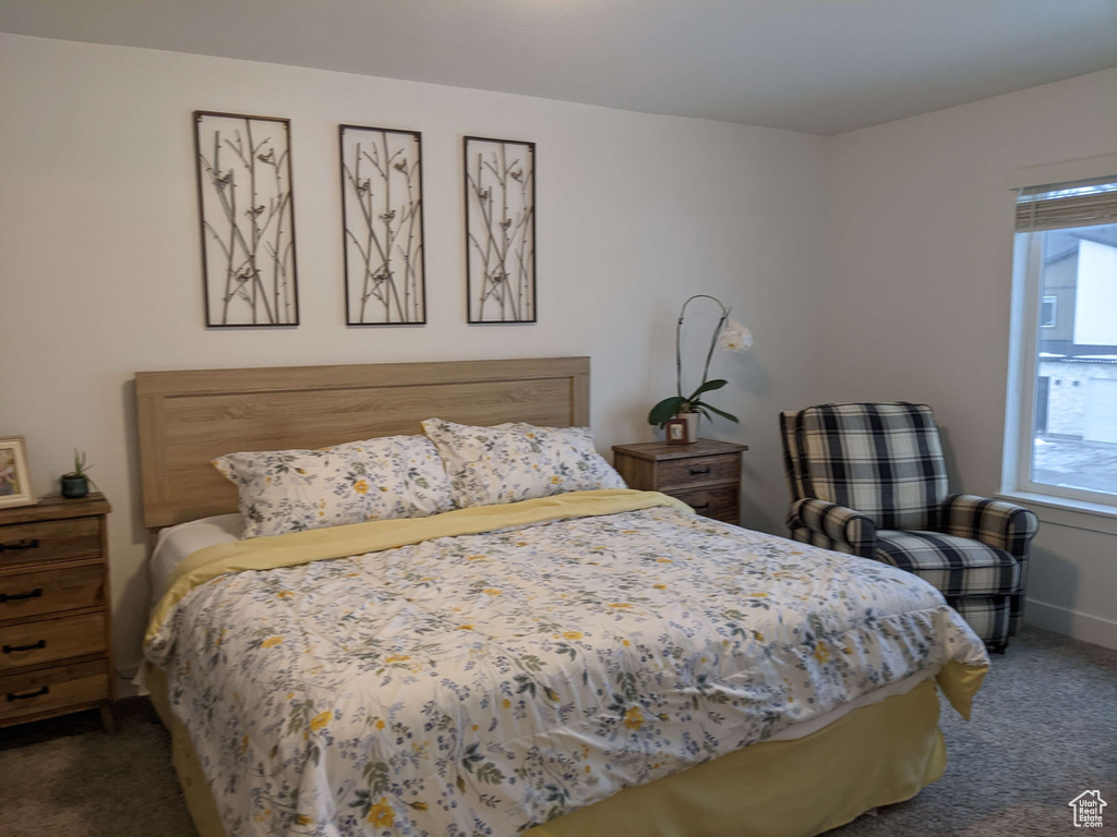 Bedroom with baseboards and carpet flooring
