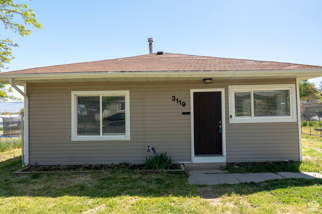 Bungalow-style house with a front lawn