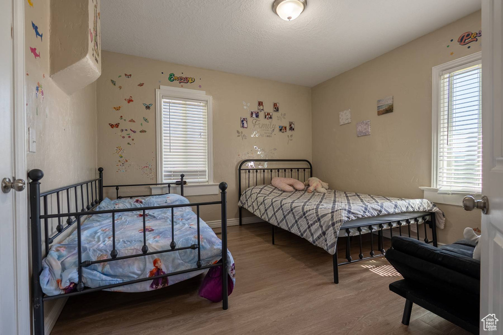 Bedroom with baseboards and wood finished floors