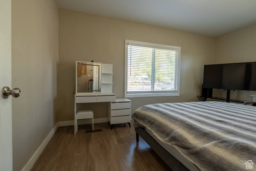 Bedroom featuring wood finished floors and baseboards