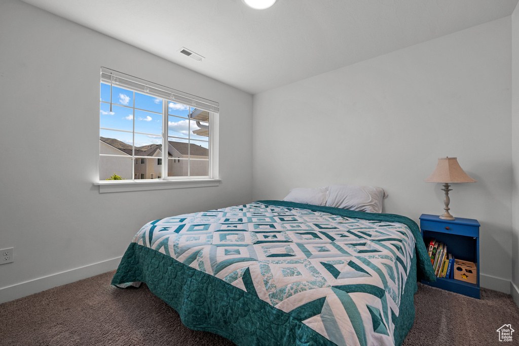 Bedroom with carpet and baseboards