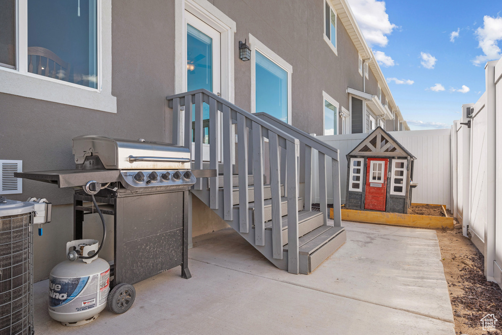 View of patio featuring fence