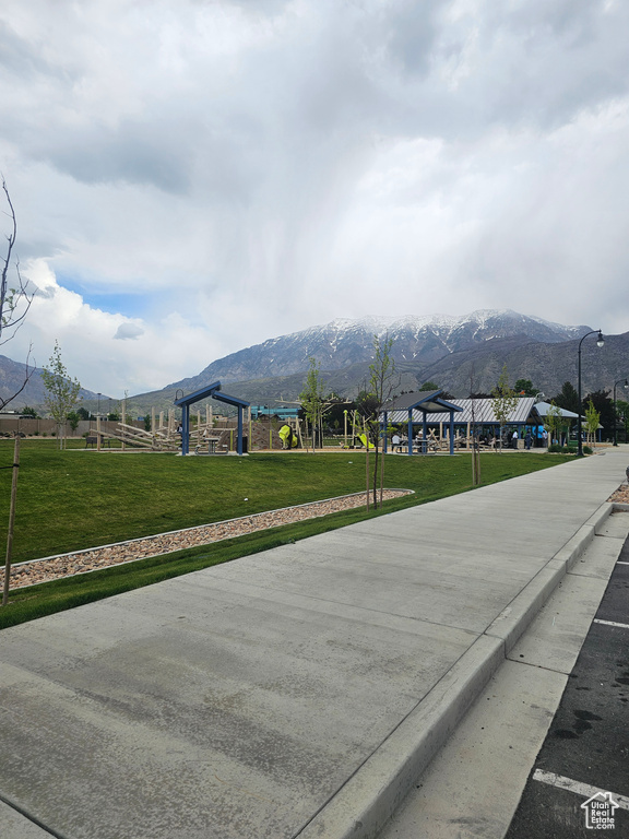View of road featuring street lighting, a mountain view, and sidewalks