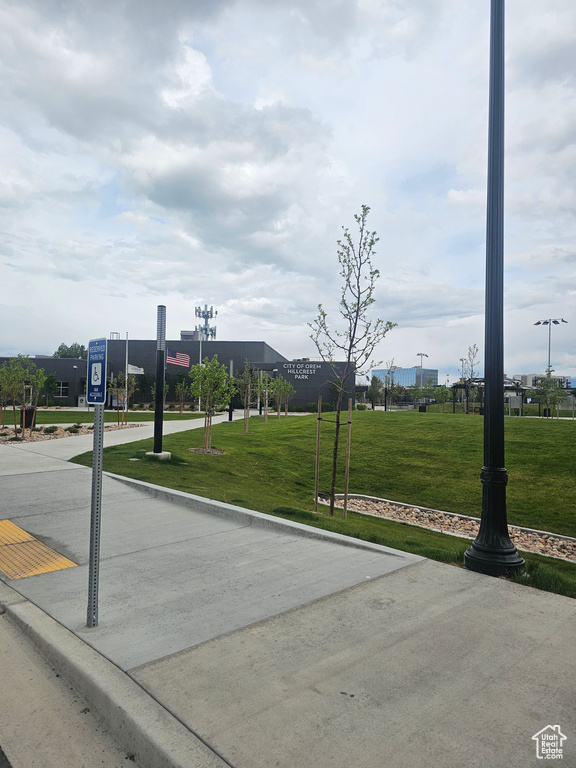 View of concrete road featuring curbs and traffic signs
