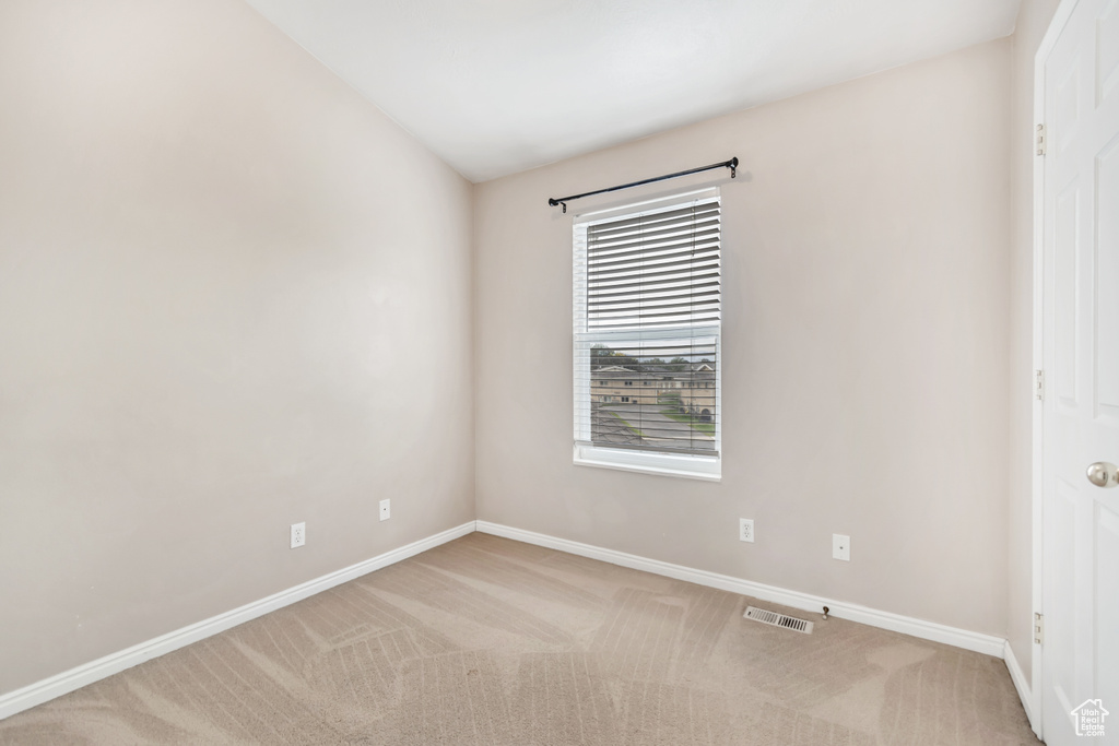 Empty room featuring carpet floors and baseboards