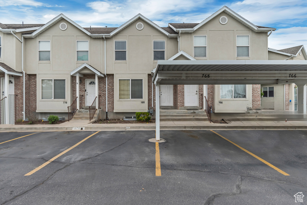 Multi unit property with entry steps, covered and uncovered parking, and stucco siding