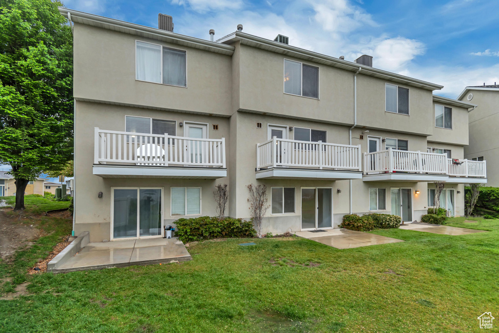 Rear view of property with stucco siding and a patio area