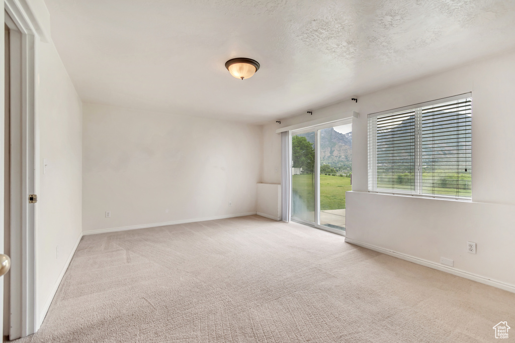Carpeted spare room with baseboards