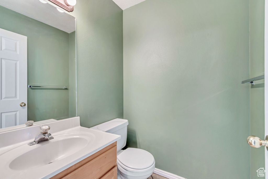 Half bath featuring toilet and vanity