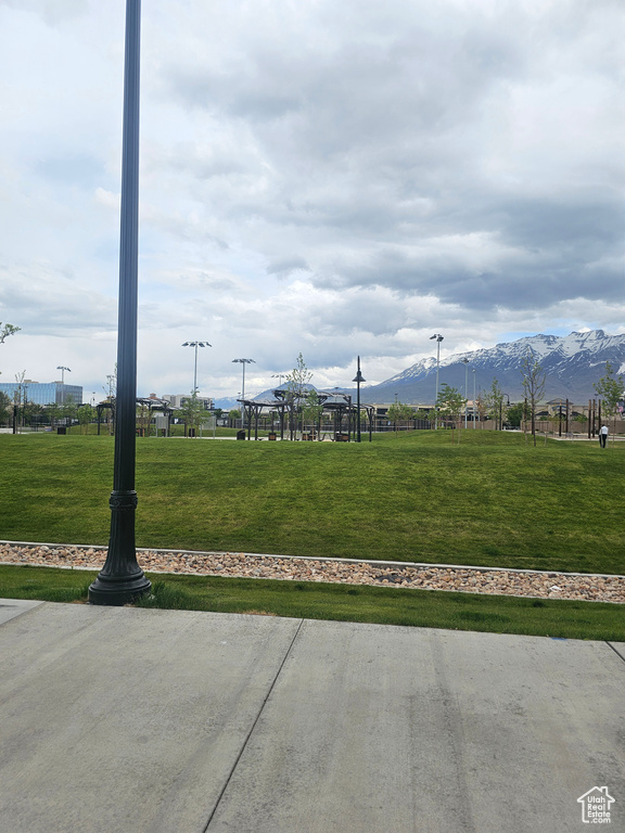 View of green lawn featuring a mountain view