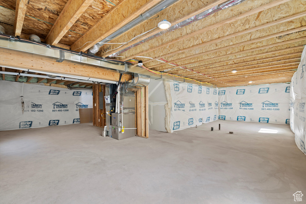 Unfinished basement featuring heating unit