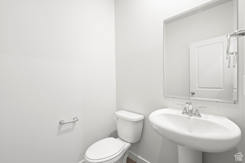 Bathroom with baseboards and toilet