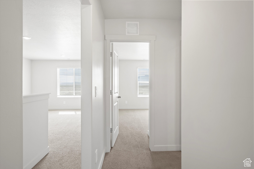 Hallway with carpet flooring