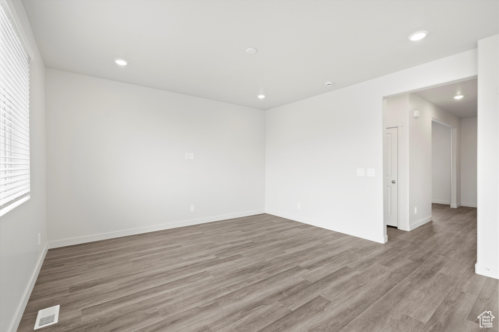 Empty room featuring wood finished floors and recessed lighting