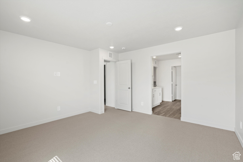 Spare room featuring carpet flooring and recessed lighting