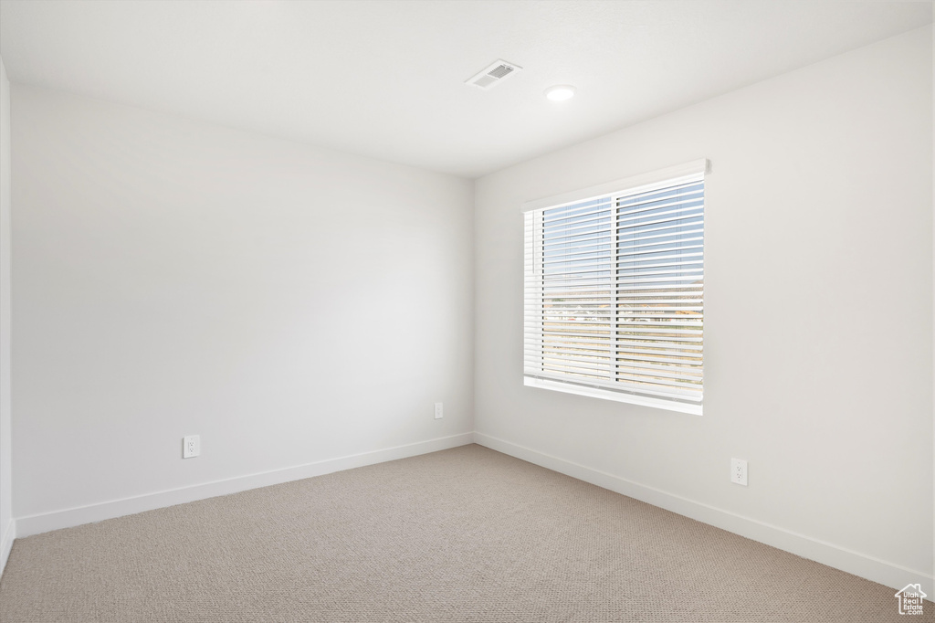 Unfurnished room featuring light colored carpet and recessed lighting
