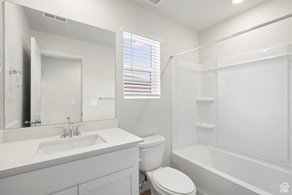 Bathroom featuring vanity and washtub / shower combination