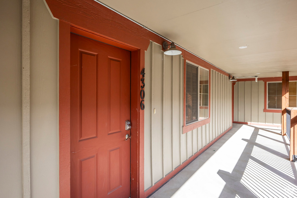 Entrance to property with a porch and board and batten siding