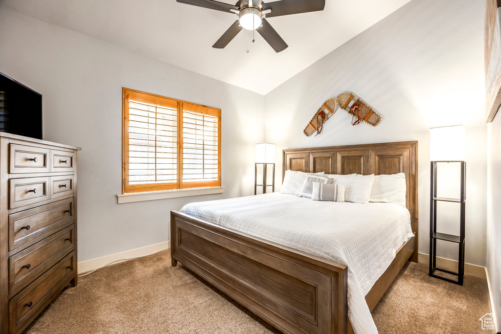 Bedroom with baseboards, a ceiling fan, and light carpet