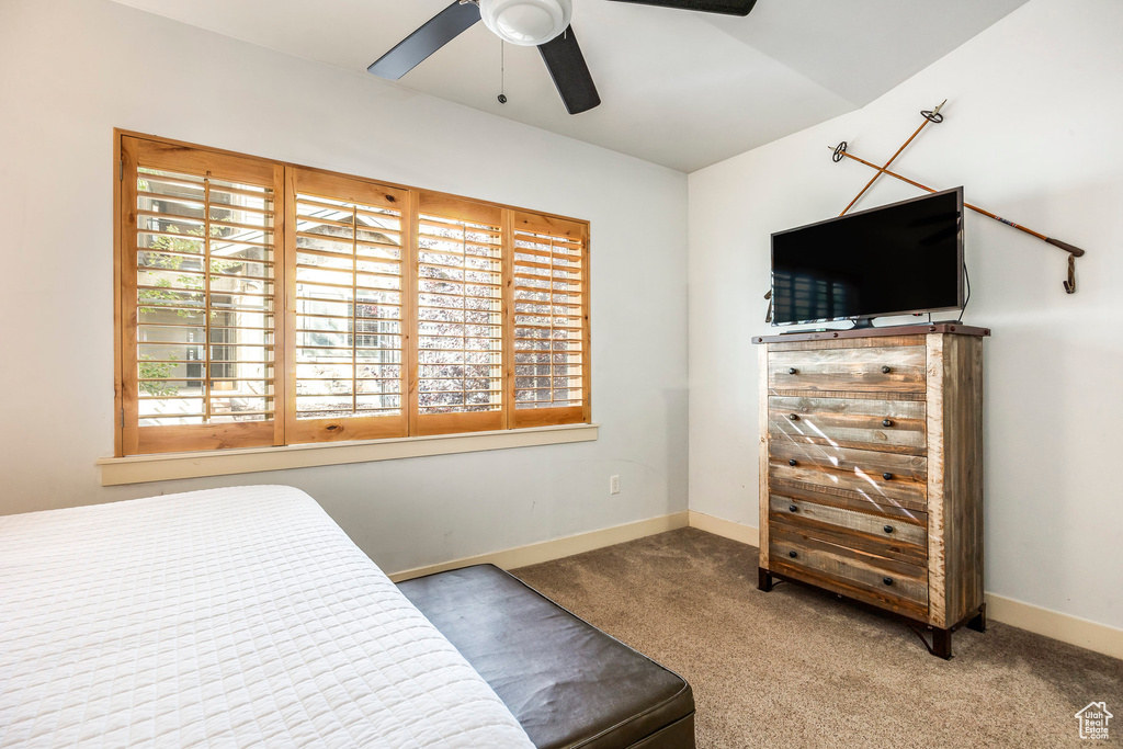 Bedroom with baseboards, ceiling fan, and carpet