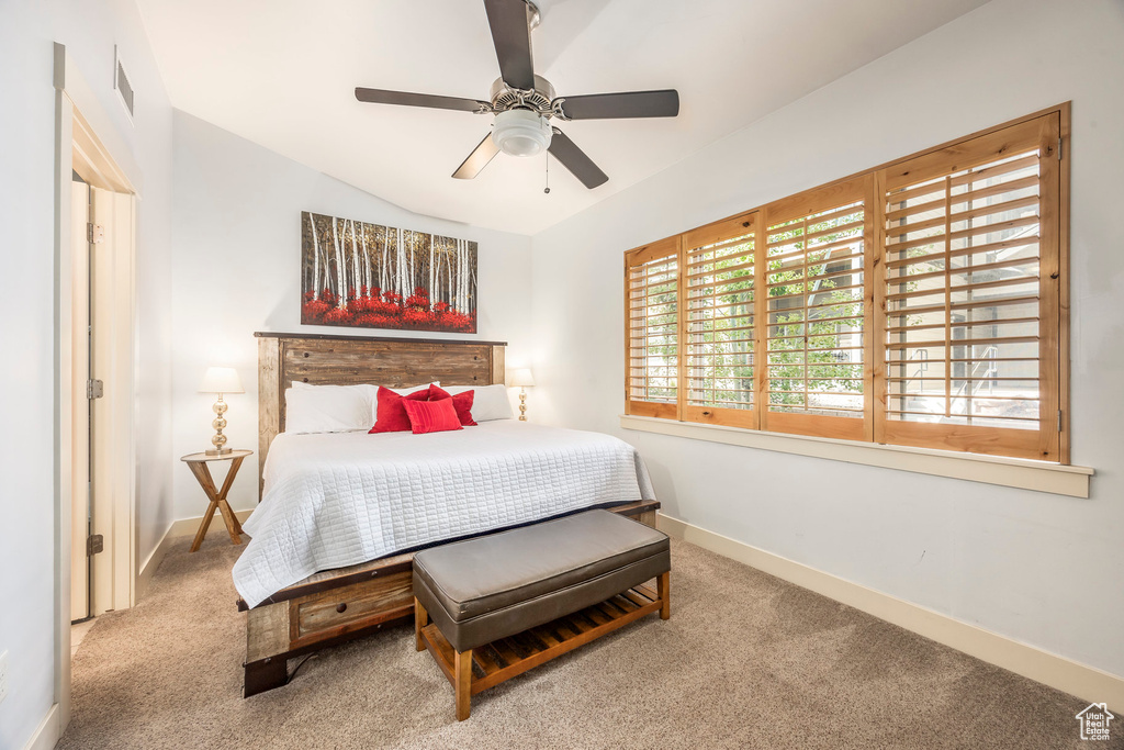 Bedroom featuring baseboards, a ceiling fan, carpet, and visible vents