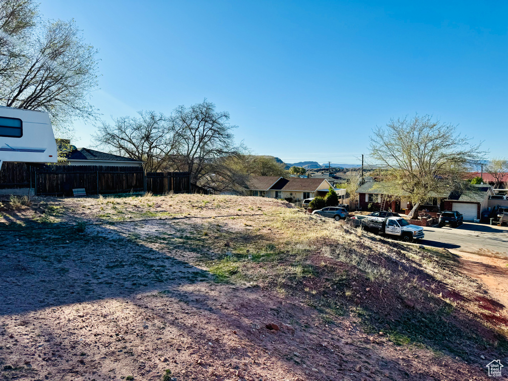 View of yard featuring fence, a residential view, and a mountain view
