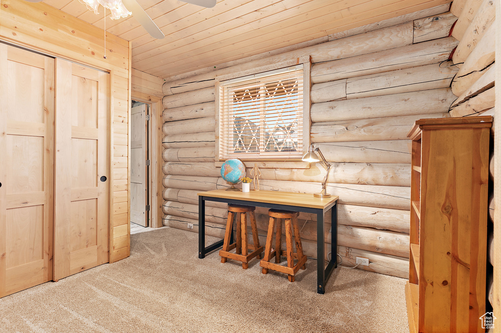 Hall featuring wood ceiling, log walls, and carpet