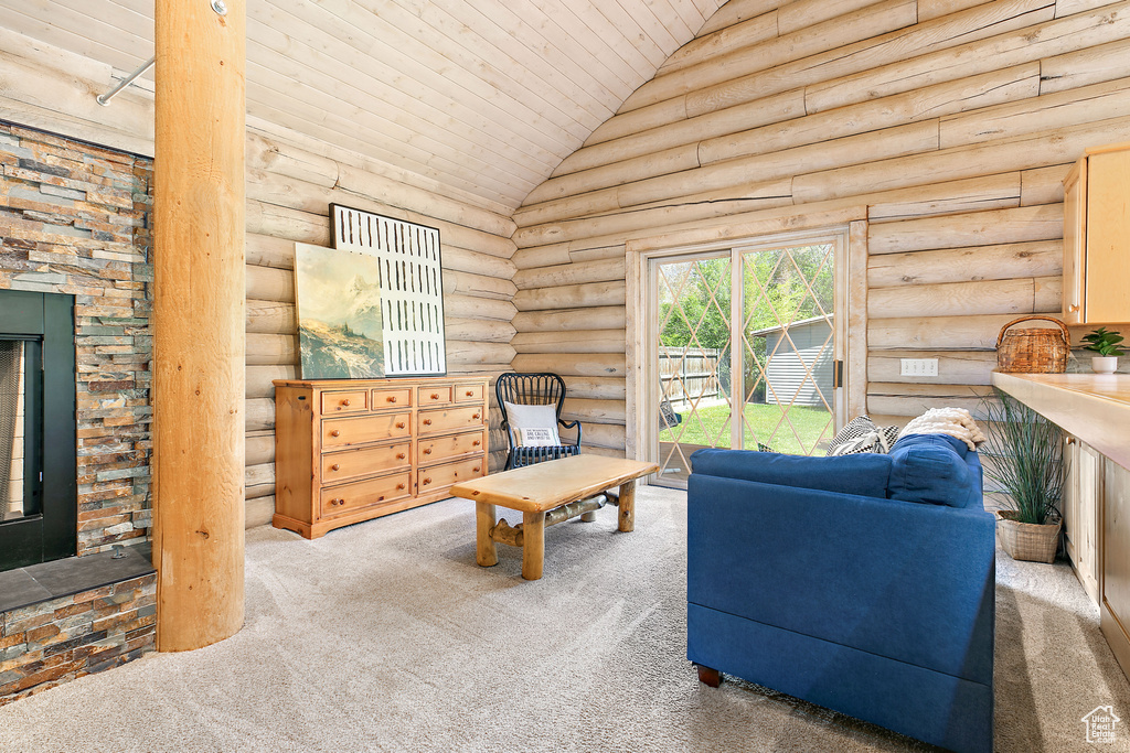Carpeted living area featuring wood ceiling, log walls, and lofted ceiling