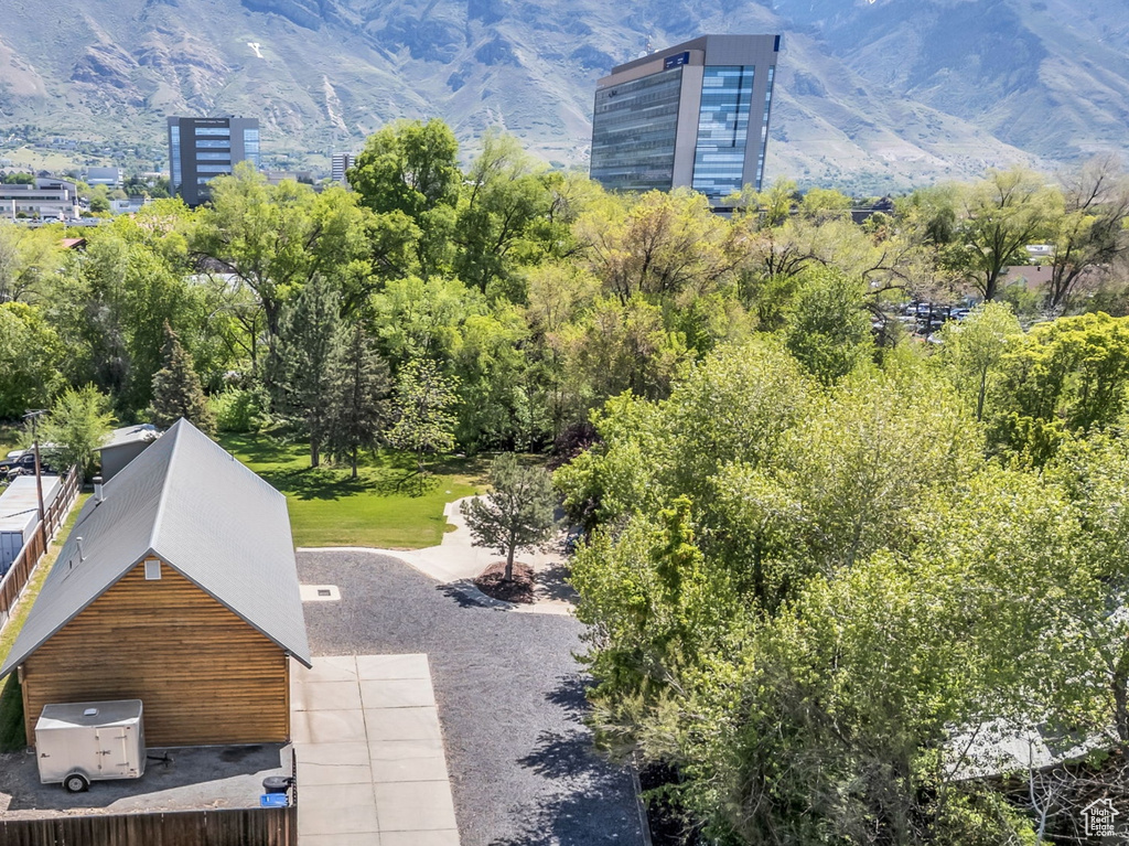 Aerial view of property and surrounding area with a mountainous background