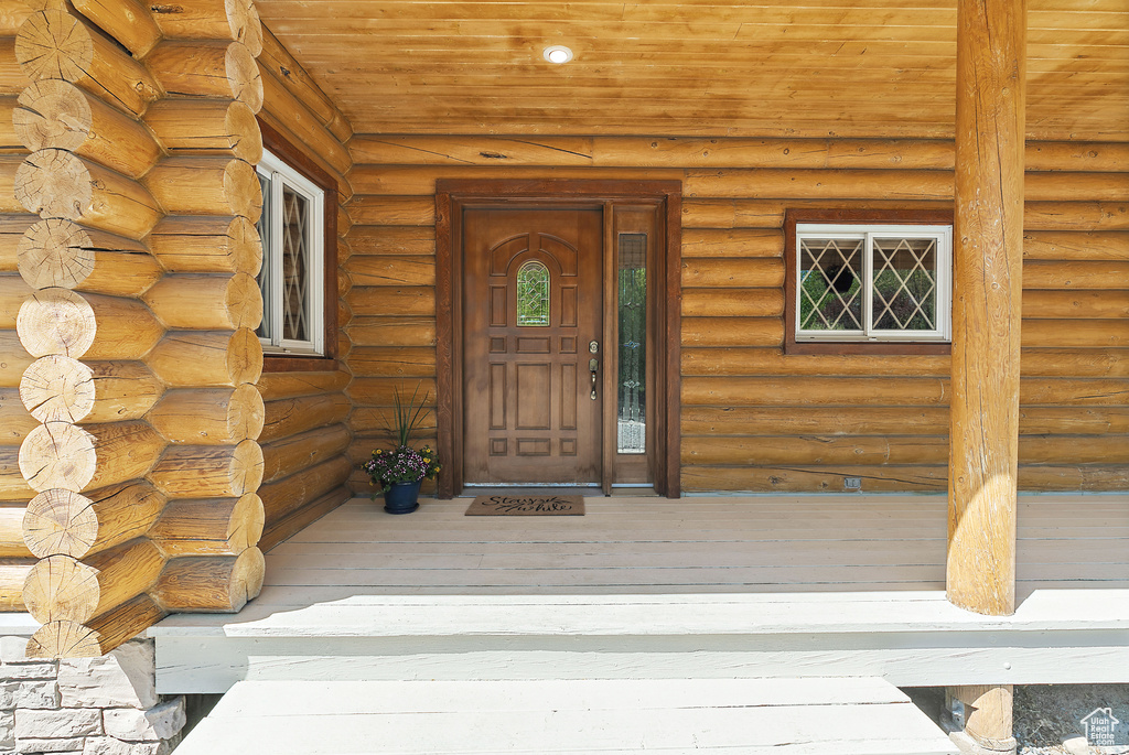 View of exterior entry with log siding