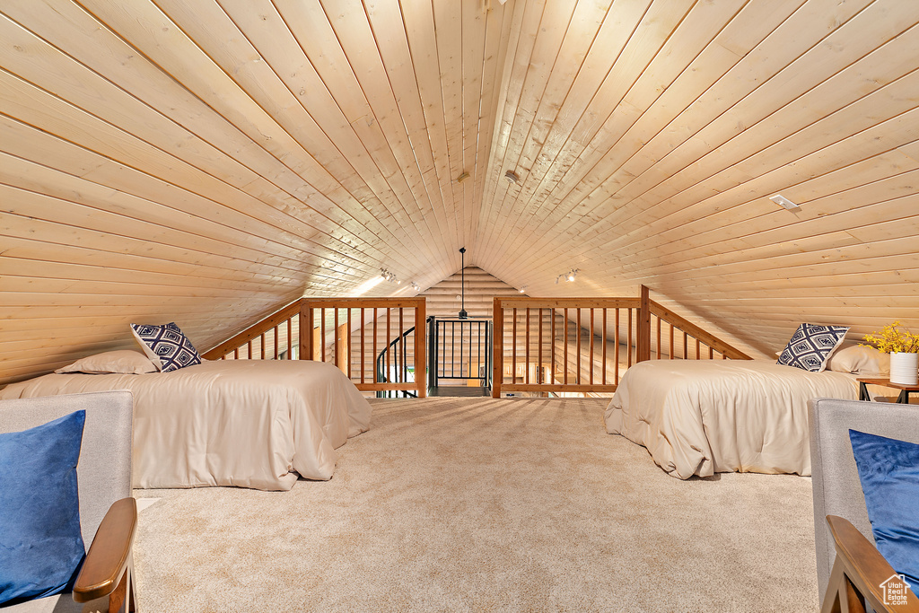 Bedroom with lofted ceiling, wood ceiling, and carpet floors