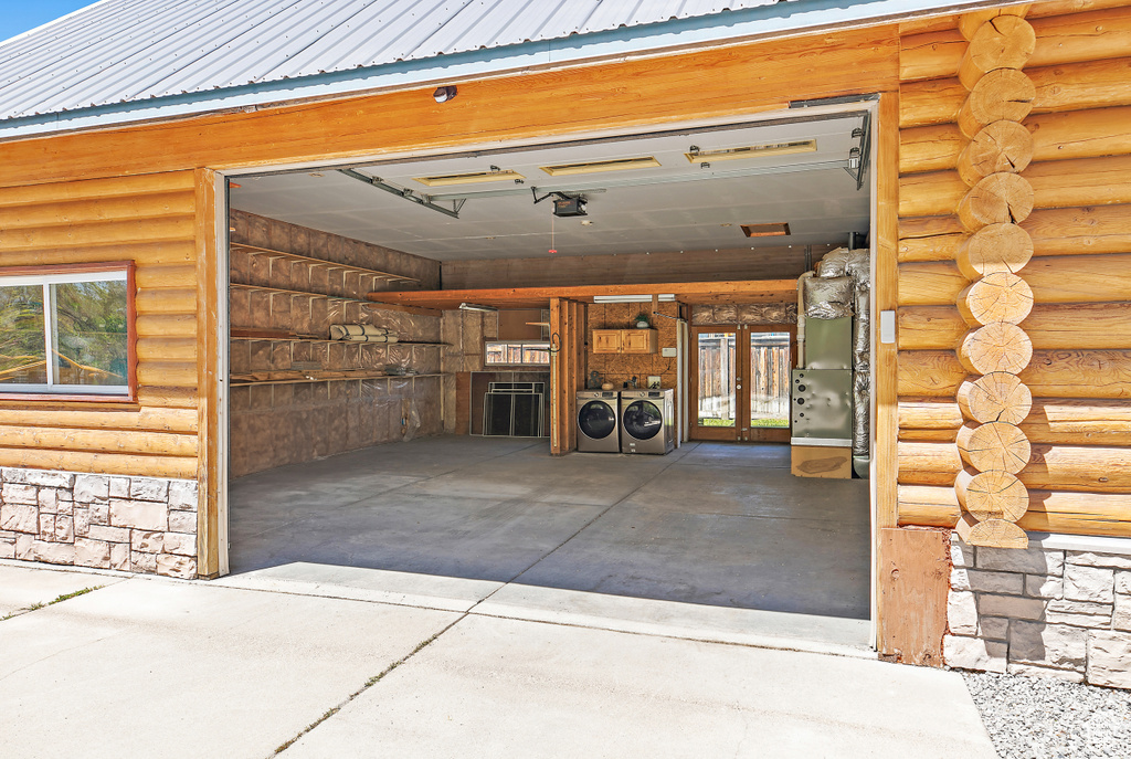 Garage featuring french doors and independent washer and dryer