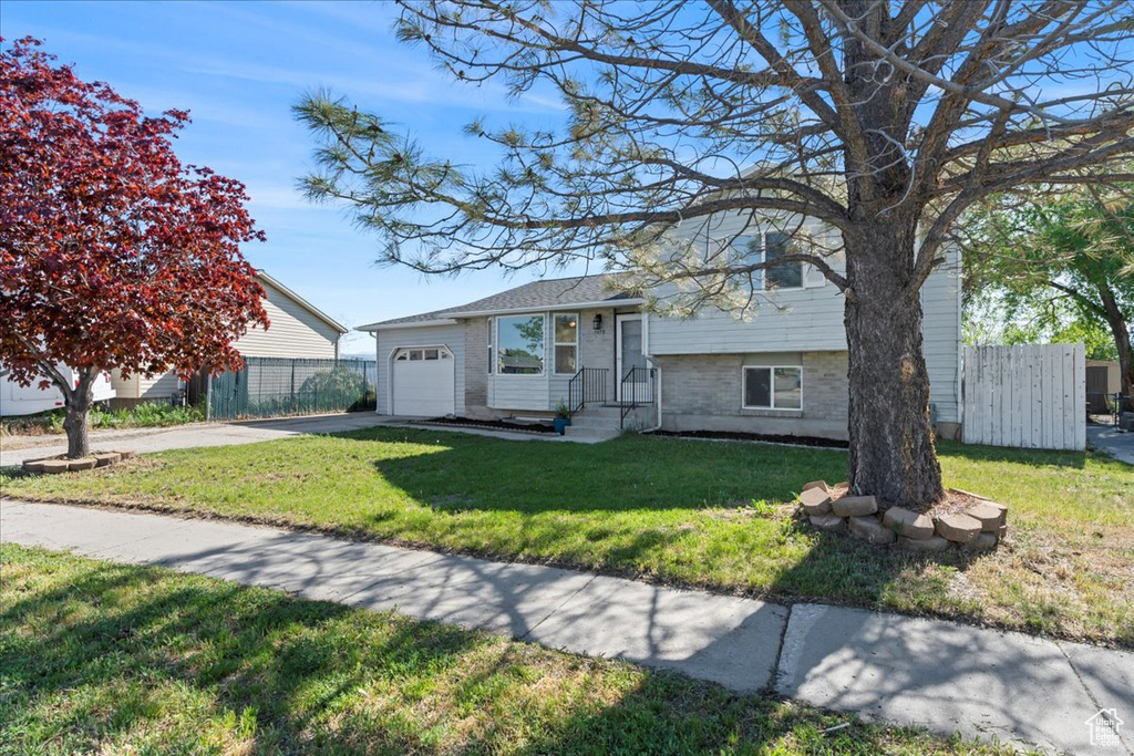 Split level home with a garage and concrete driveway