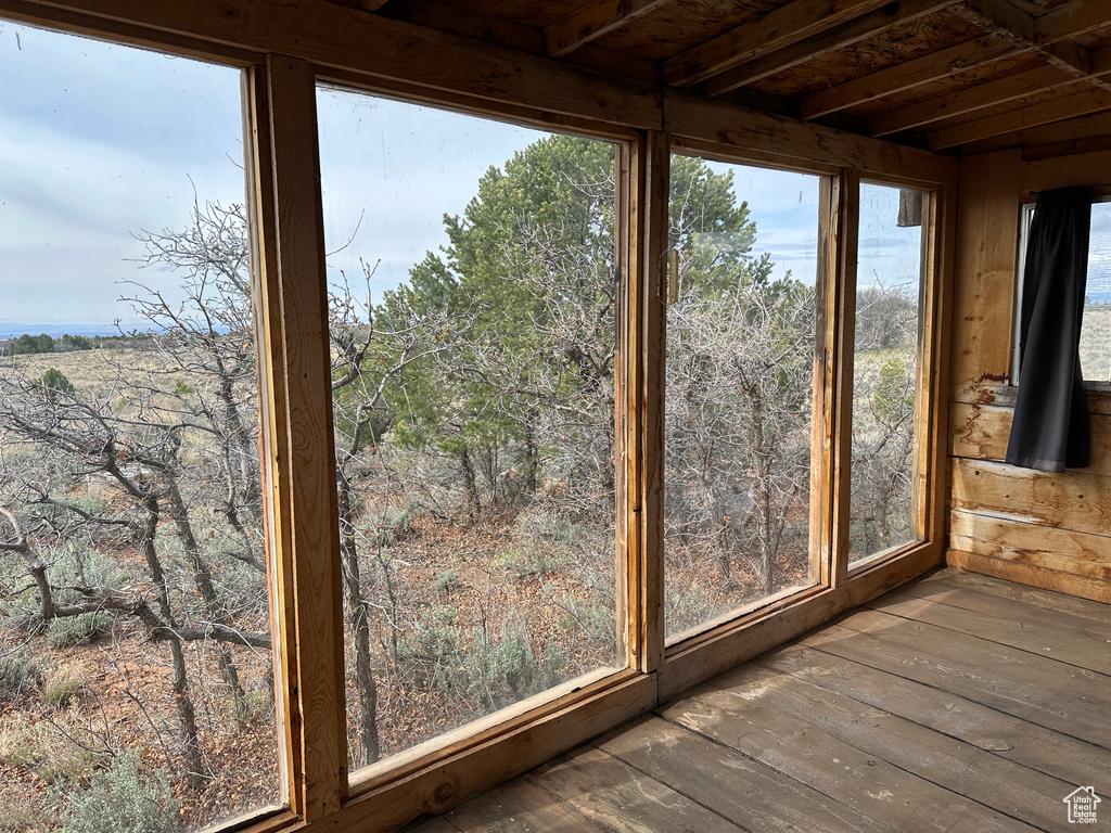 Unfurnished sunroom featuring wood-type flooring