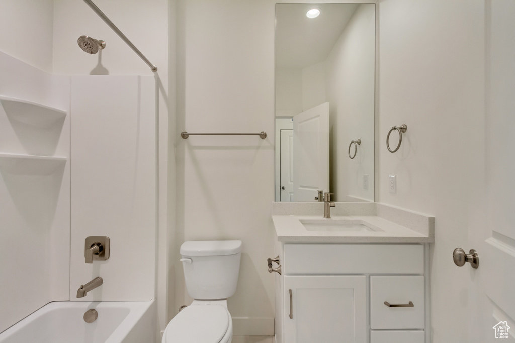 Full bathroom with toilet, vanity, and shower / bath combination