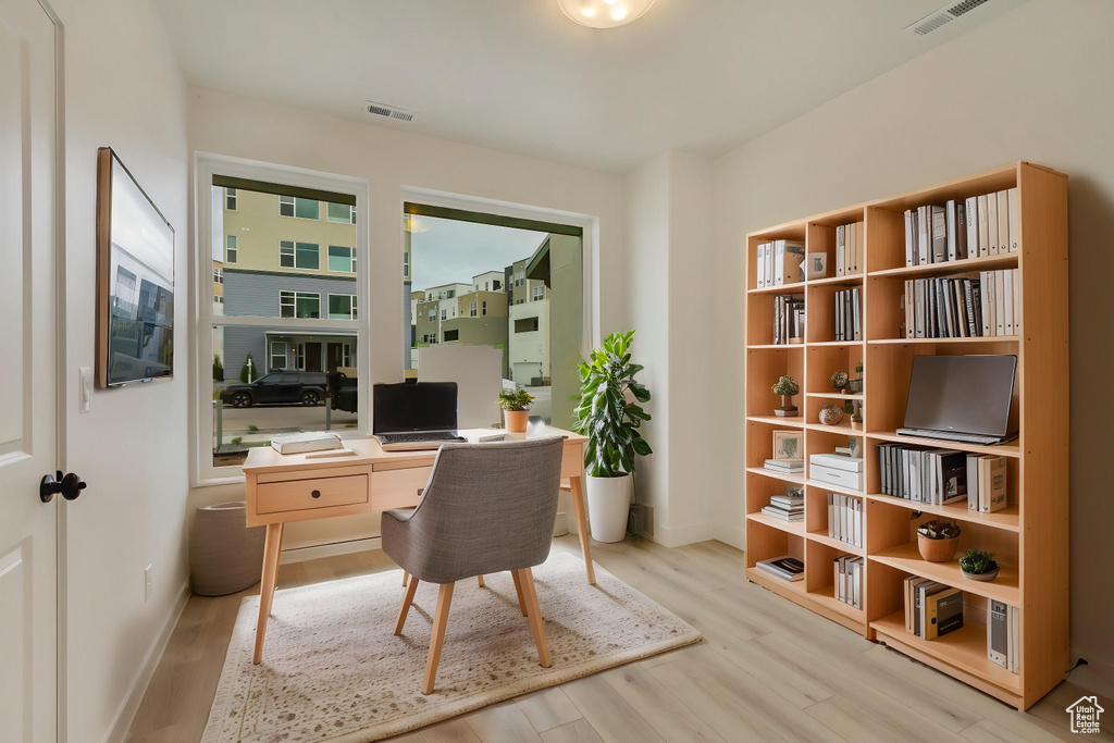 Office space with wood finished floors and baseboards