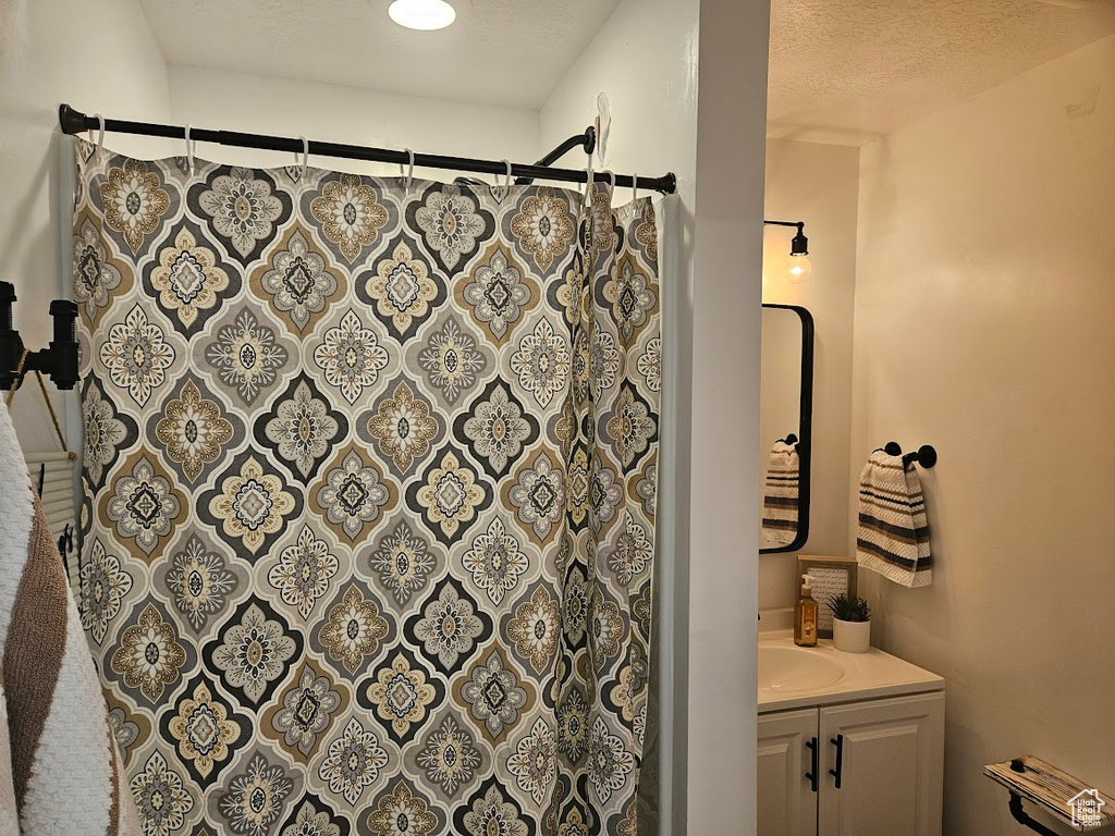 Full bathroom with vanity and a shower with shower curtain