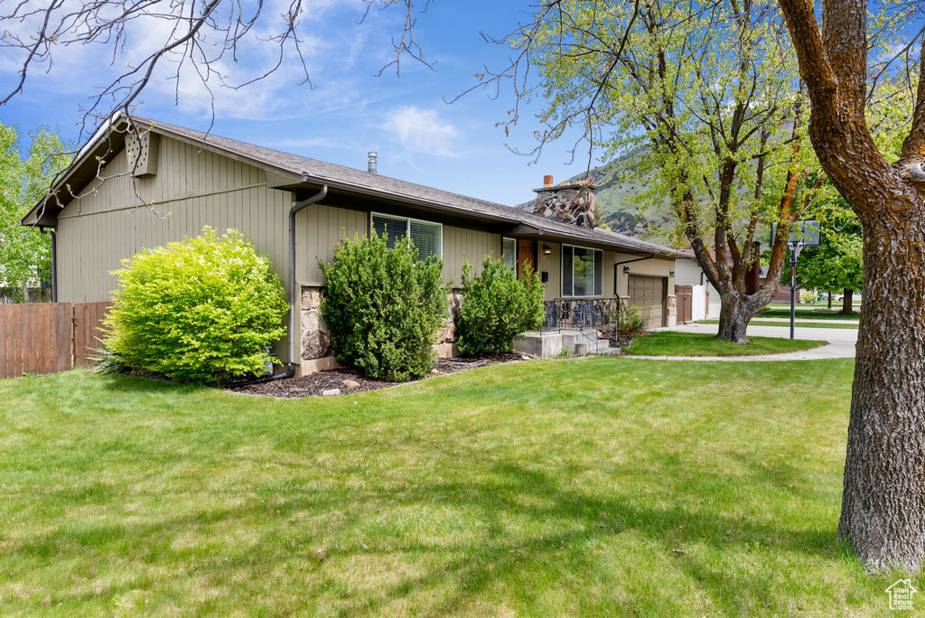 View of front of home with an attached garage and a chimney