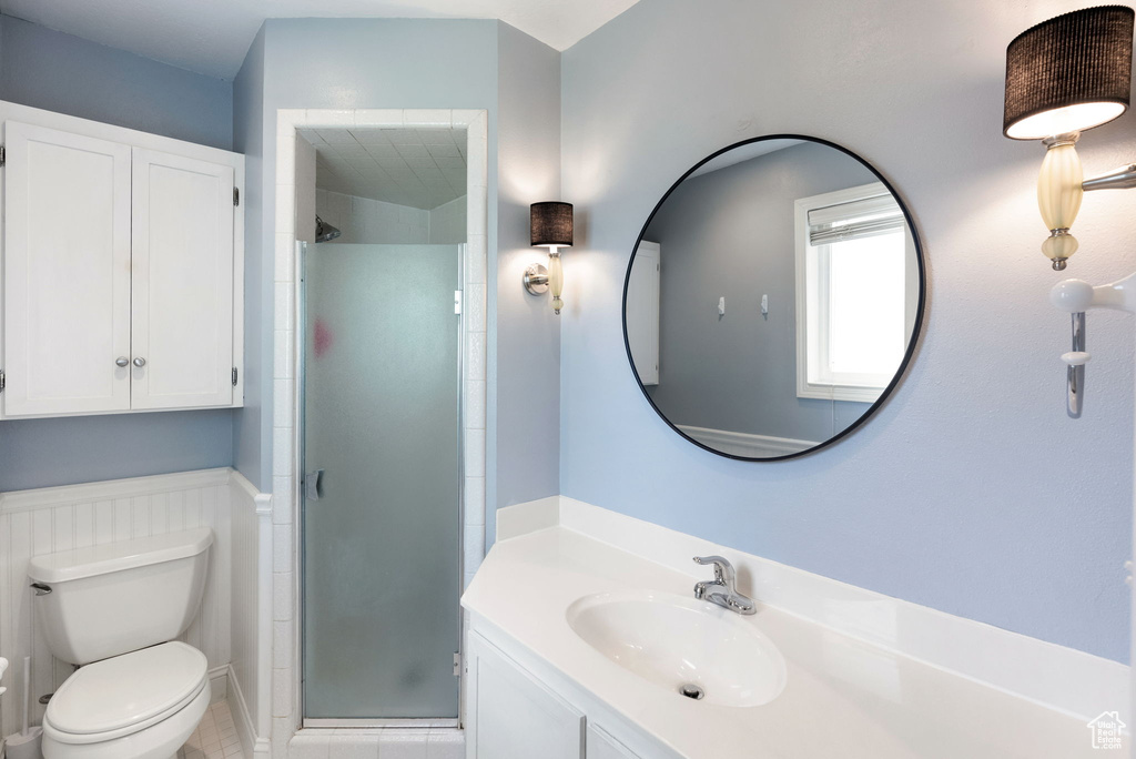 Full bathroom with a shower stall, toilet, tile patterned flooring, and vanity