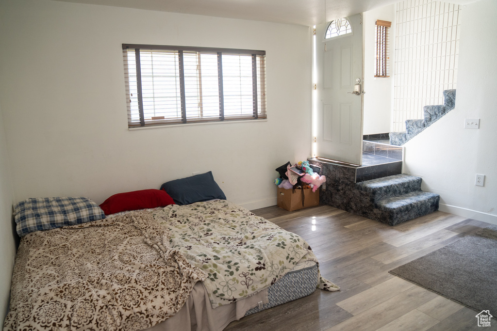 Bedroom featuring wood finished floors and baseboards