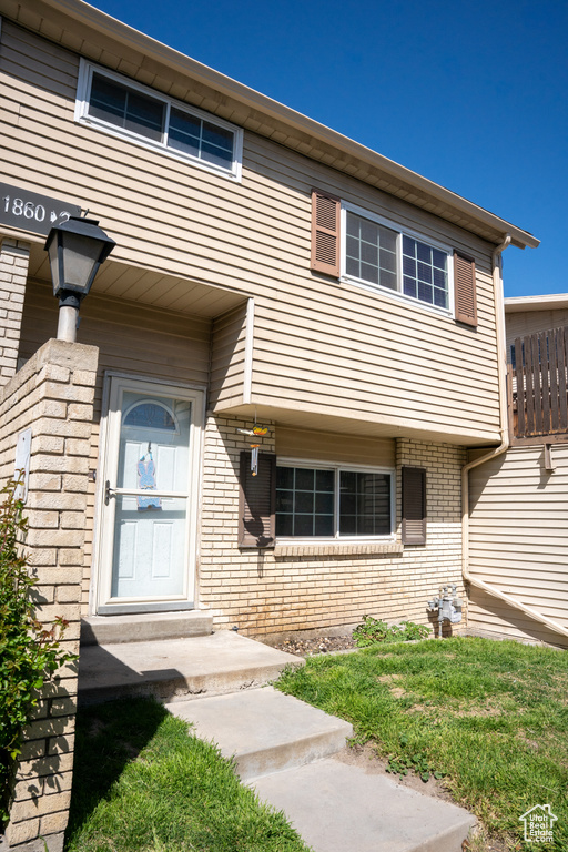 Property entrance featuring brick siding