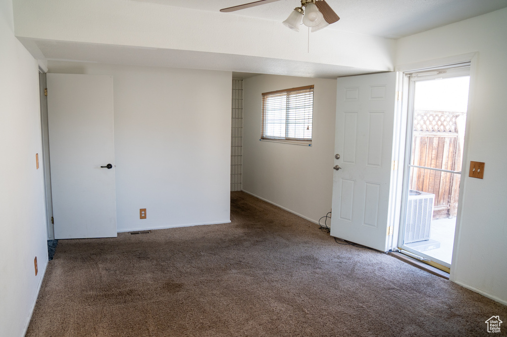Unfurnished room with carpet floors and a ceiling fan