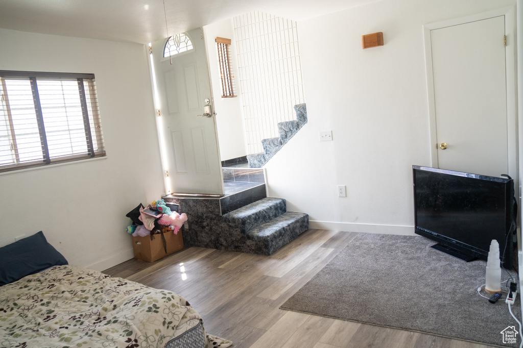 Bedroom with wood finished floors and baseboards