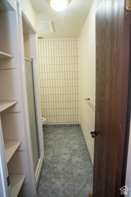 Bathroom featuring a stall shower and toilet
