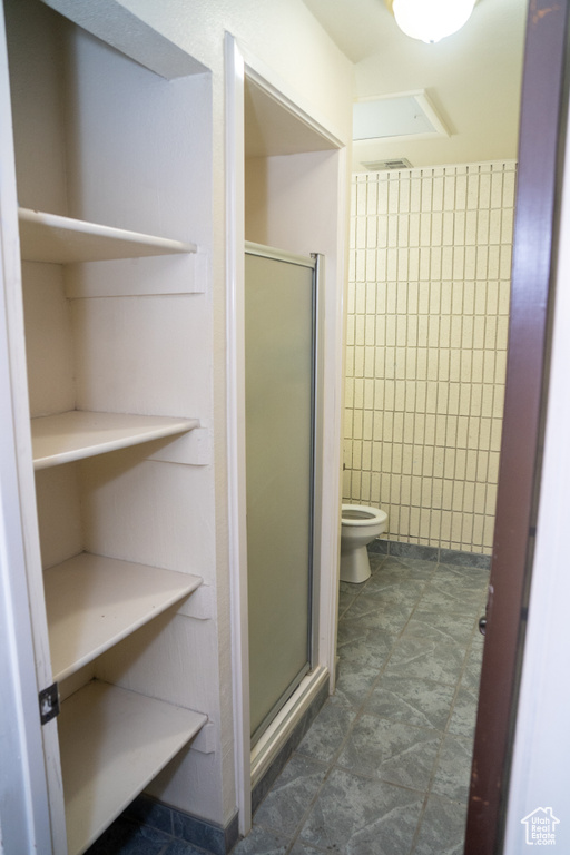 Bathroom with a stall shower and toilet