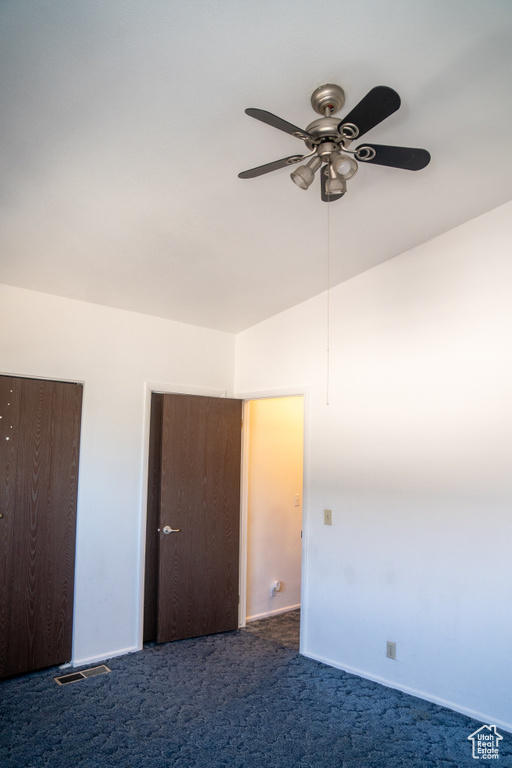 Unfurnished bedroom with carpet flooring, baseboards, and ceiling fan