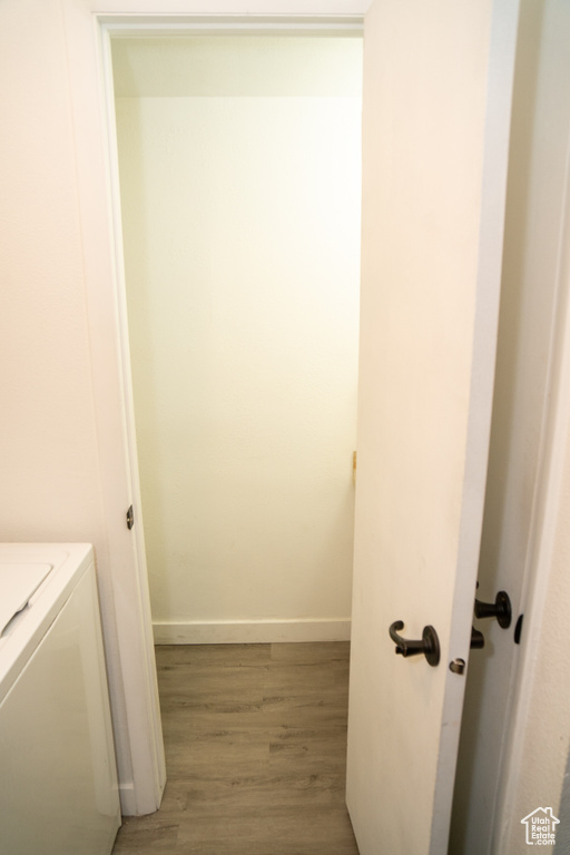 Interior space with washer / dryer, light wood-type flooring, and baseboards