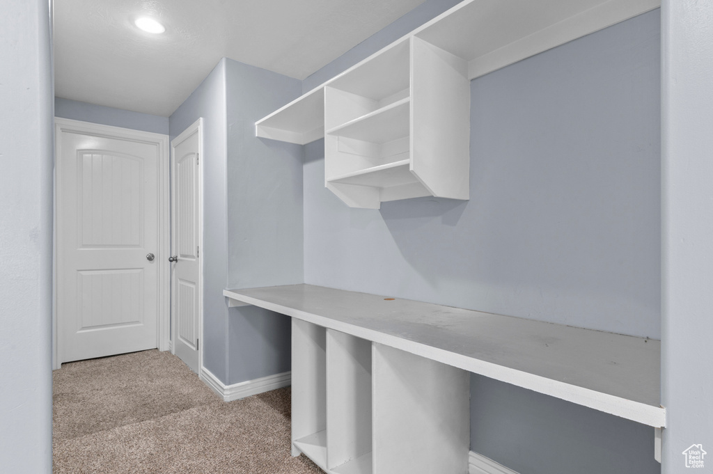 Walk in closet with carpet floors