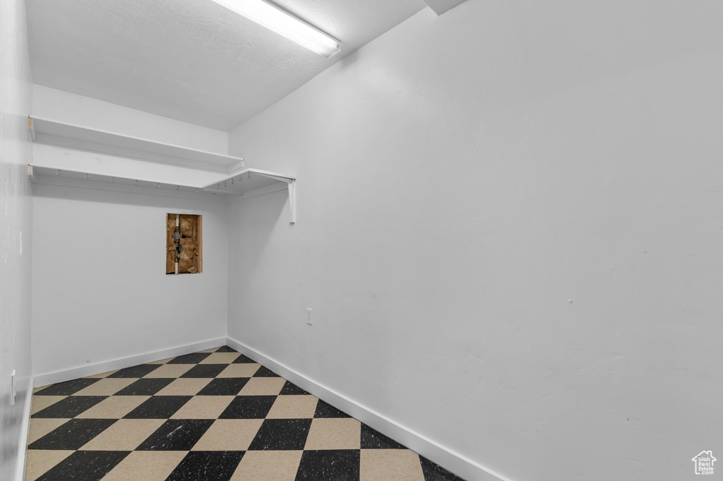 Spacious closet with tile patterned floors