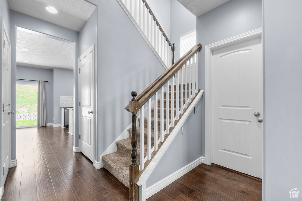 Stairway featuring wood finished floors and baseboards